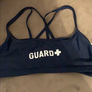 Navy swimsuit with the word “guard” on it.
